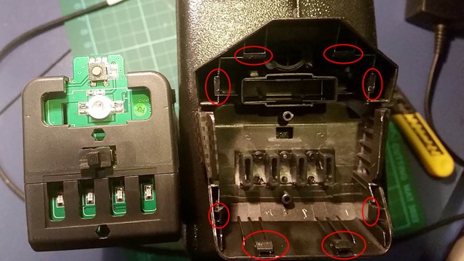 Scout X4 battery cover tabs location for removal.