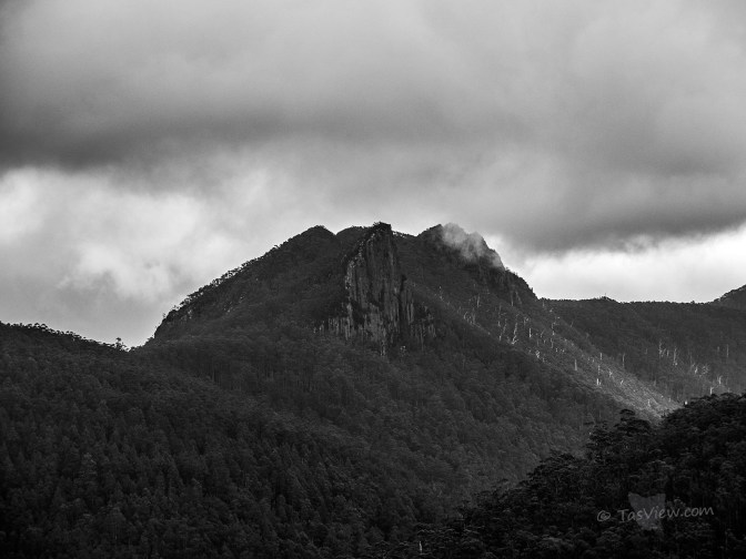 A stormy sky over the rugged rock face of Mt Montagu behind Mt Wellington - in Mono.