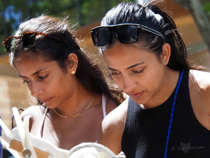 Two girls browsing in the Hobart sunshine.